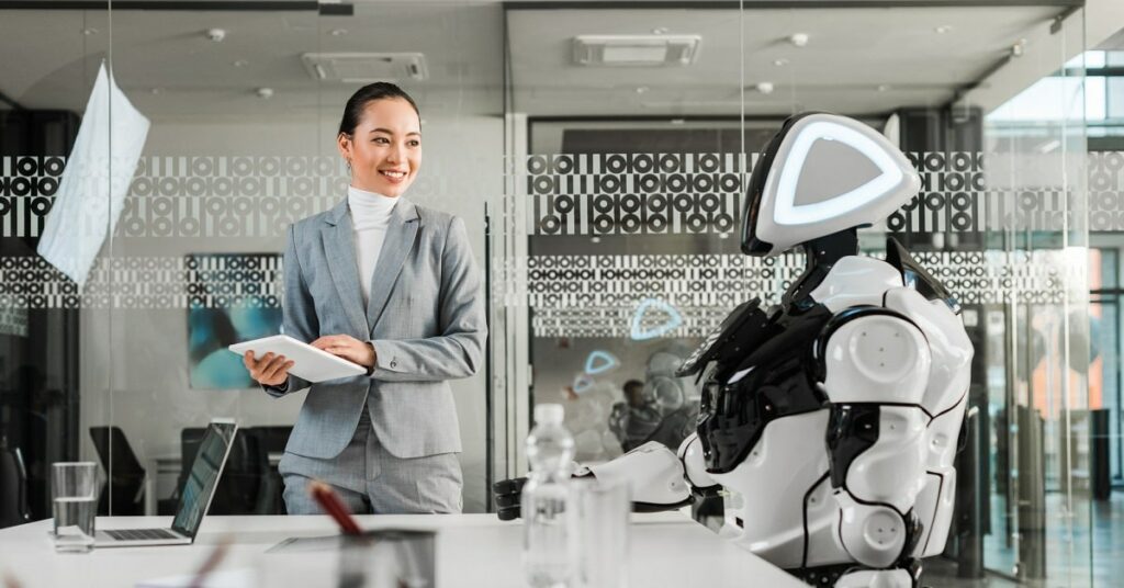 What is AI? A Beginner’s Guide for Business, Everyday Life and Academia Boss looking at a robot doing its desk job.